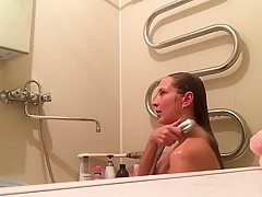 Hidden camera in the bathroom filming hot MILF taking shower